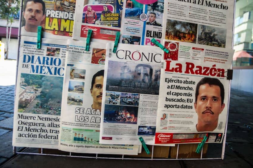 newspapers on rack all reporting about el mencho